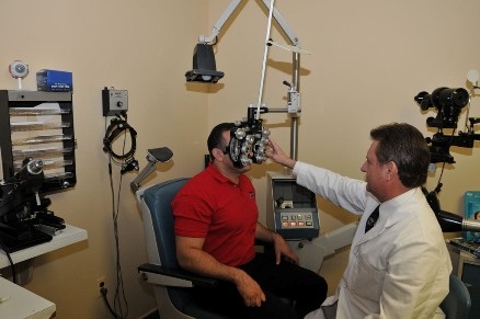 Dr. Brinker performing a refraction with a phoropter
